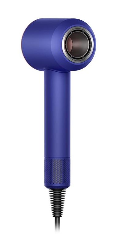 Woman with the Dyson Supersonic hair dryer with the diffuser attachment. 